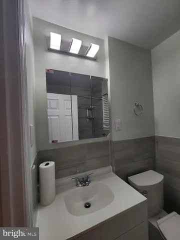 a bathroom with a toilet a sink and a mirror