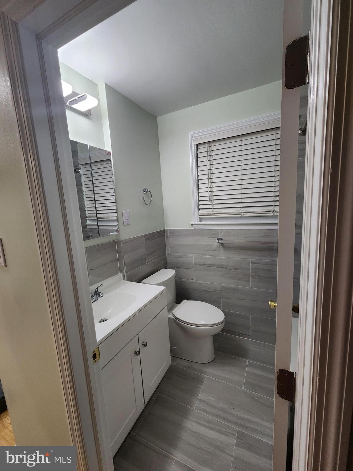 8303 Ridgeway Street Philadelphia, PA 19111 - Photo 21 of 24 a bathroom with a toilet a sink and a mirror