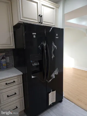 a kitchen with stainless steel appliances granite countertop a sink refrigerator and cabinets