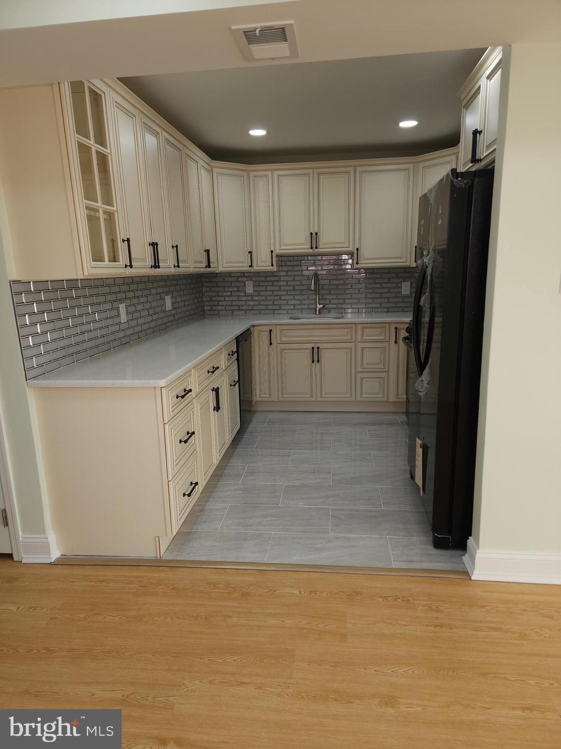 8303 Ridgeway Street Philadelphia, PA 19111 - Photo 9 of 24 a kitchen with stainless steel appliances granite countertop a sink refrigerator and cabinets