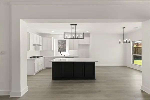 a spacious bathroom with a sink and a mirror