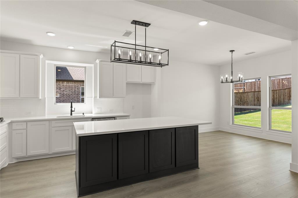 968 Gold Finch Lane Forney, TX 75126 - Photo 12 of 27 a kitchen with a sink a window and wooden floor