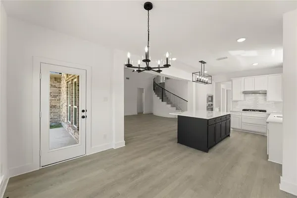 a view of a kitchen with a sink and refrigerator