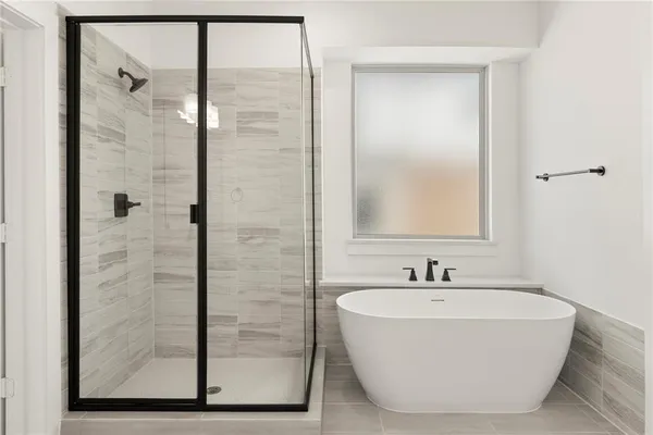 a bathroom with a bathtub and shower