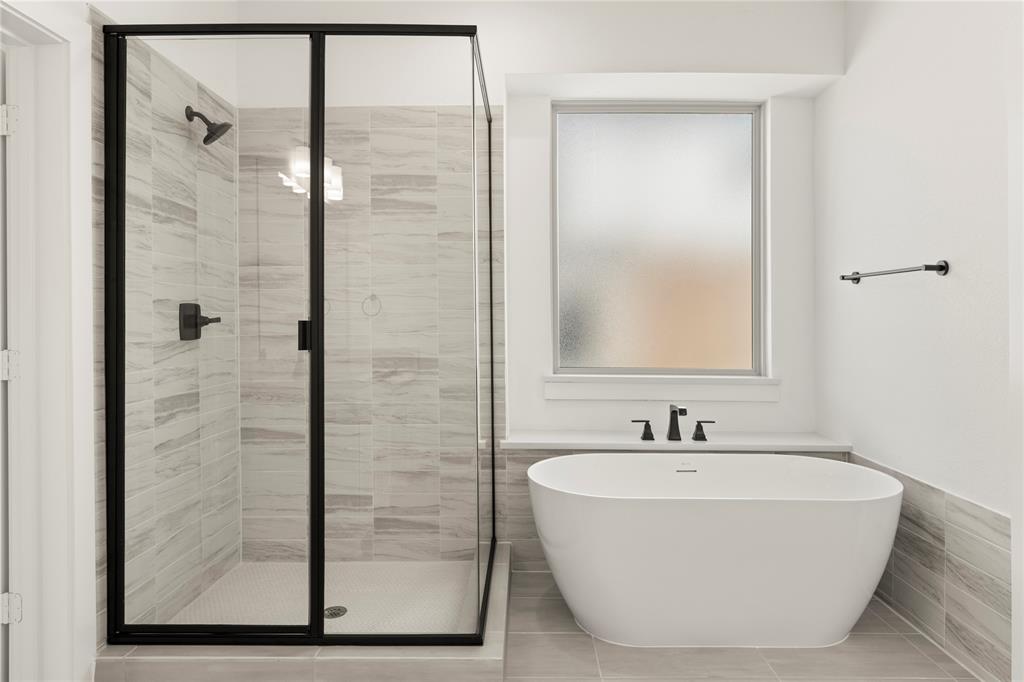 968 Gold Finch Lane Forney, TX 75126 - Photo 19 of 27 a bathroom with a bathtub and shower