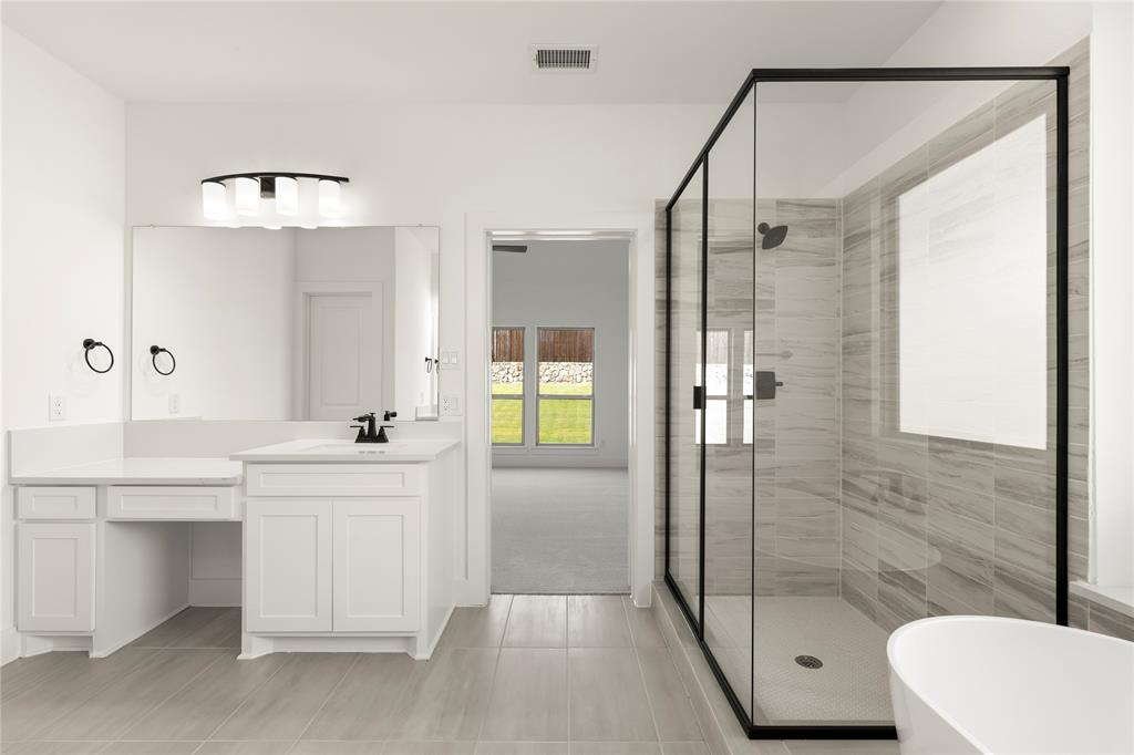 968 Gold Finch Lane Forney, TX 75126 - Photo 21 of 27 a bathroom with a sink a toilet and shower