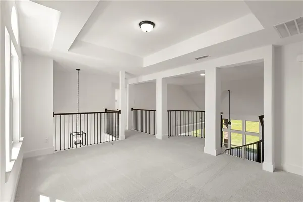 an empty room with windows and closet