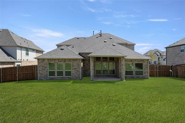 a view of a house with a yard and sitting area