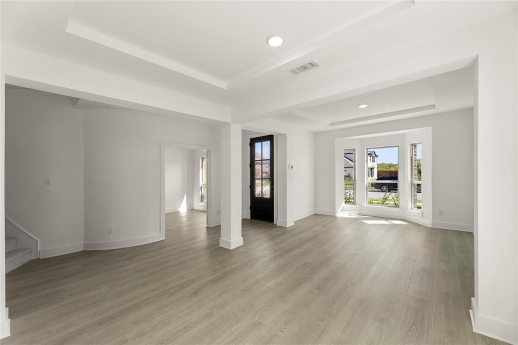968 Gold Finch Lane Forney, TX 75126 - Photo 4 of 27 a view of an empty room with wooden floor and a window