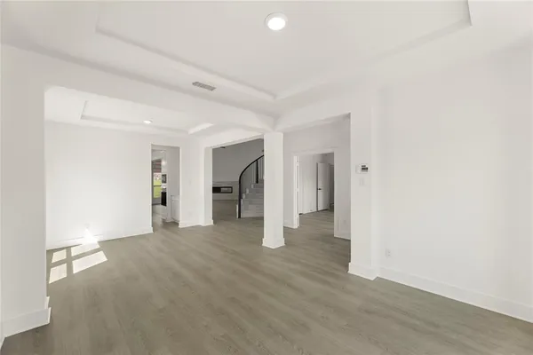 a view of empty room with wooden floor