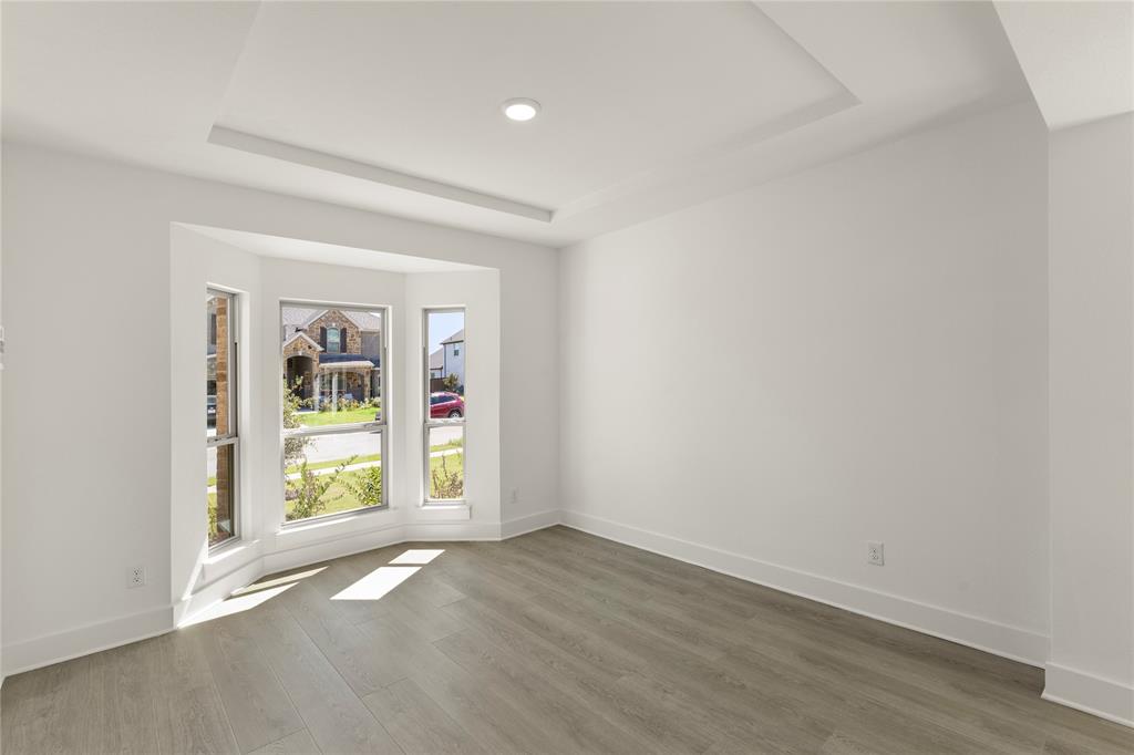 968 Gold Finch Lane Forney, TX 75126 - Photo 8 of 27 an empty room with wooden floor and door