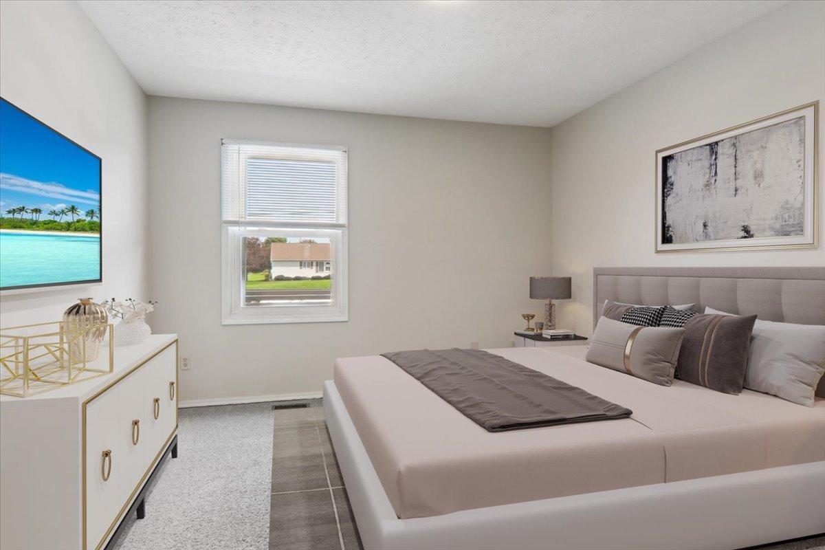 600 Carriage Hills Road, Unit A Normal, IL 61761 - Photo 13 of 19 a bedroom with a bed and a flat screen tv