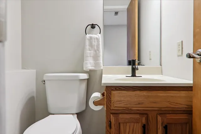 a bathroom with a toilet sink and mirror