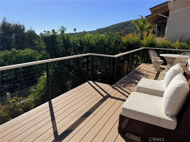 a view of a balcony with wooden floor and outdoor space