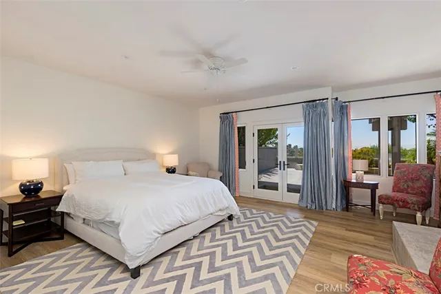 a bedroom with a bed wooden floor and lamp