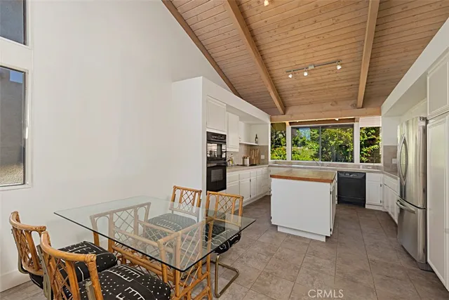 a living room with furniture a window and kitchen view