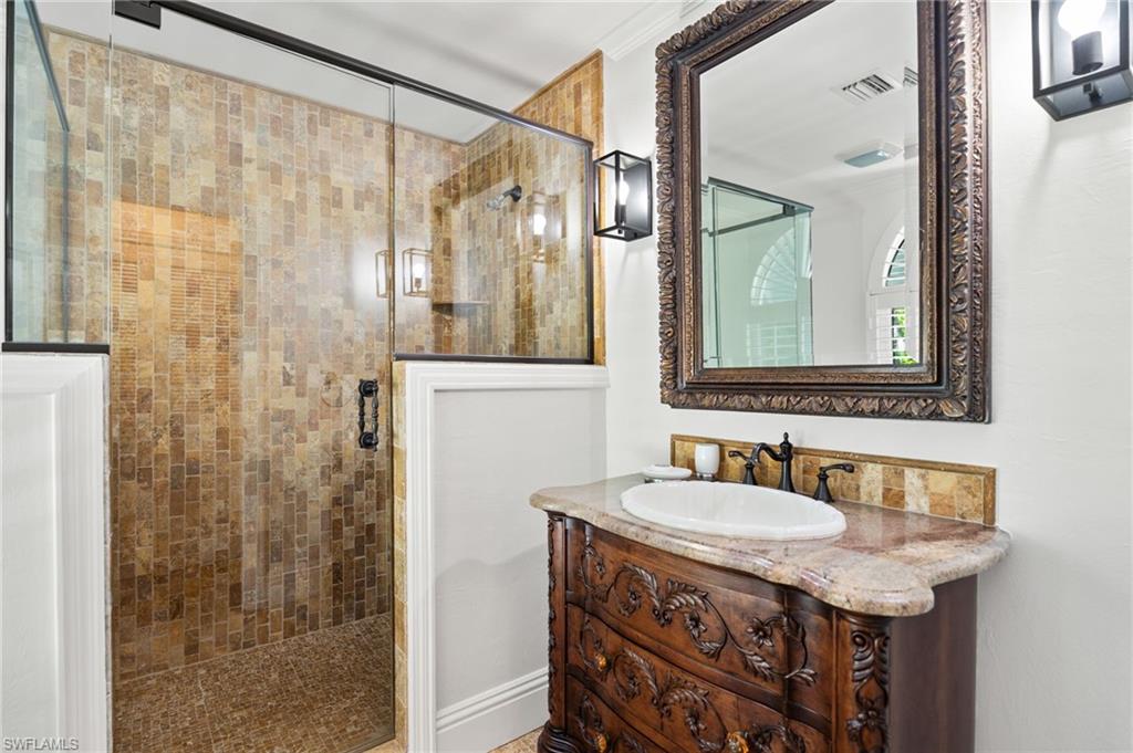 2201 Beacon Lane Naples, FL 34103 - Photo 20 of 25 a bathroom with a sink and a mirror