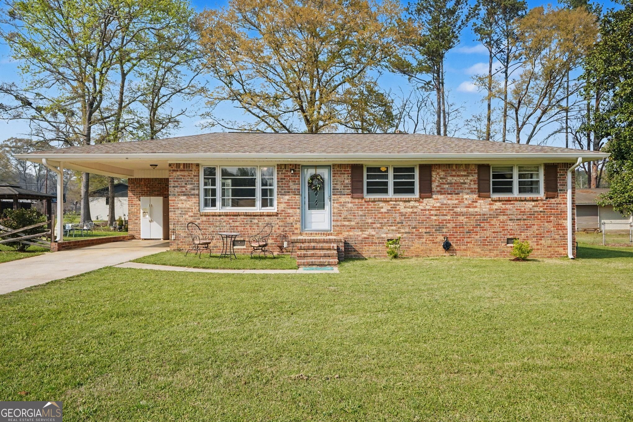 117 Dobbins Mill Road Griffin, GA 30223 - Photo 2 of 27 a front view of a house with a garden and yard