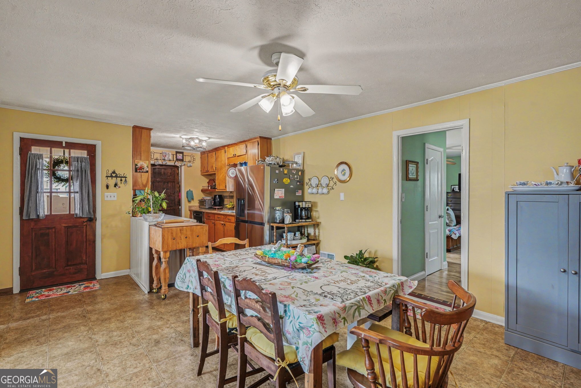117 Dobbins Mill Road Griffin, GA 30223 - Photo 9 of 27 a dining room with furniture a chandelier and a rug