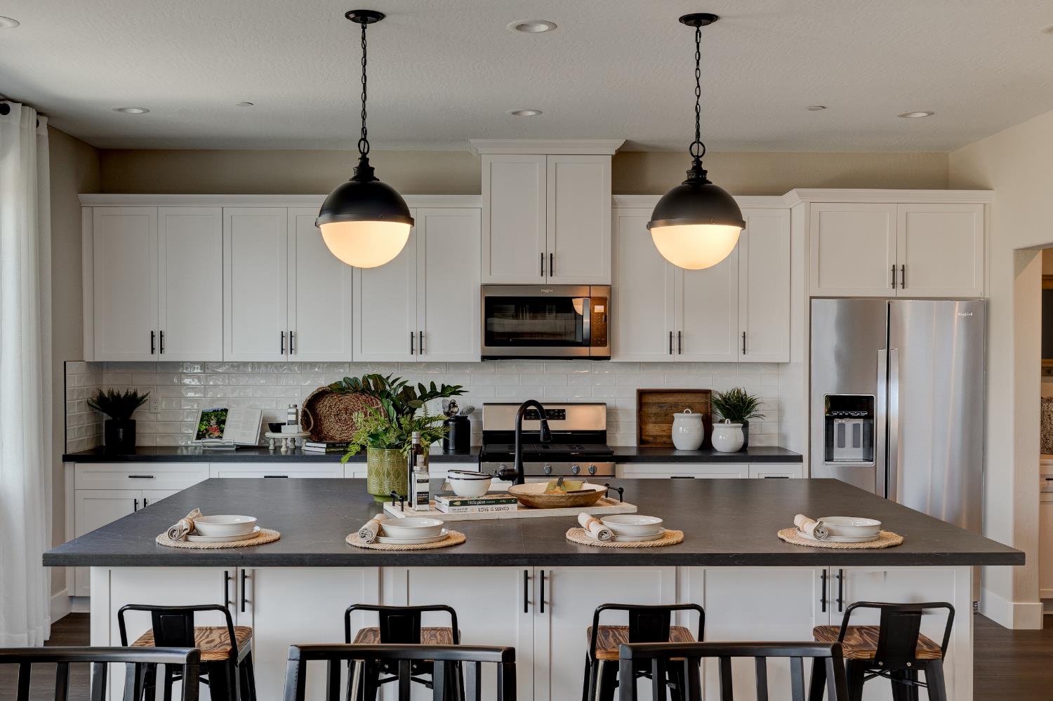 1179 Maclure Avenue Madera, CA 93636 - Photo 13 of 36 a kitchen with stainless steel appliances granite countertop a sink a stove a refrigerator and a dining table with wooden floor