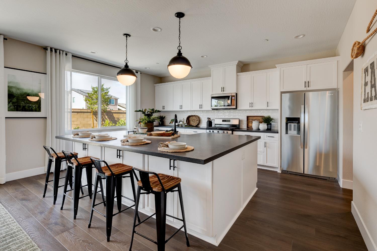1179 Maclure Avenue Madera, CA 93636 - Photo 14 of 36 a kitchen with a dining table stainless steel appliances cabinets and a center island