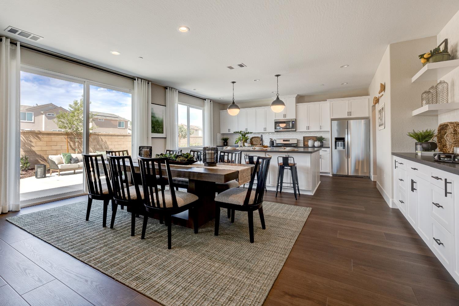1179 Maclure Avenue Madera, CA 93636 - Photo 15 of 36 a view of a dining room with furniture window and wooden floor
