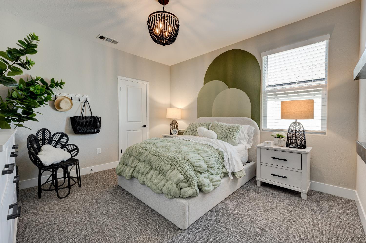 1179 Maclure Avenue Madera, CA 93636 - Photo 33 of 36 a spacious bedroom with a bed and a chandelier