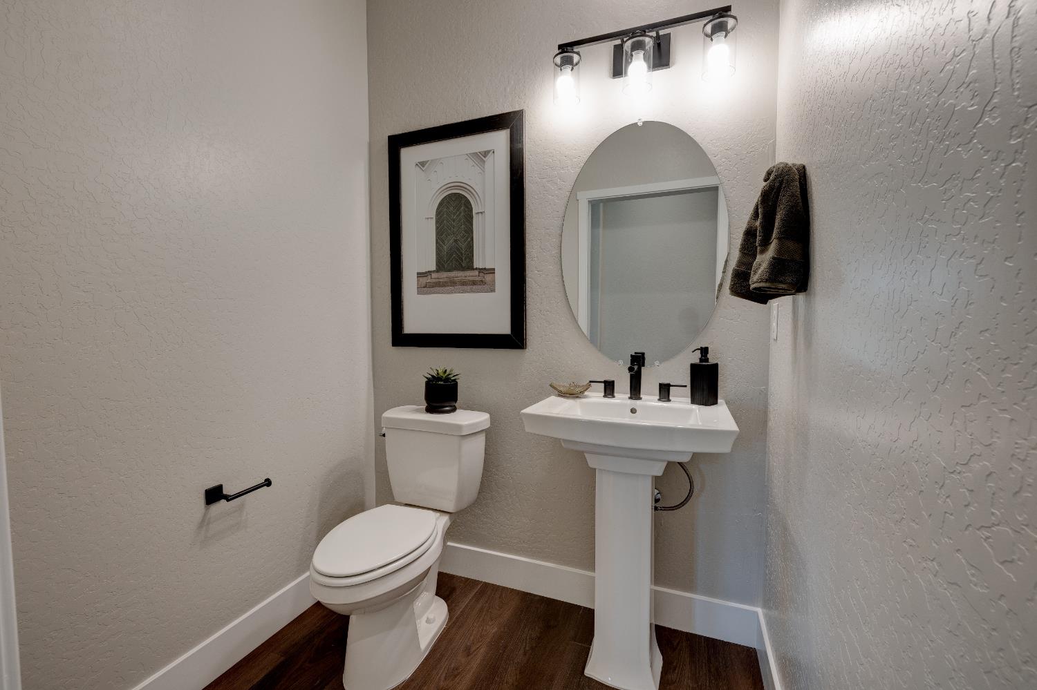 1179 Maclure Avenue Madera, CA 93636 - Photo 7 of 36 a bathroom with a toilet sink and mirror