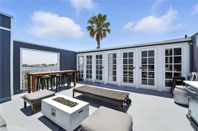 a balcony with furniture and a potted plant
