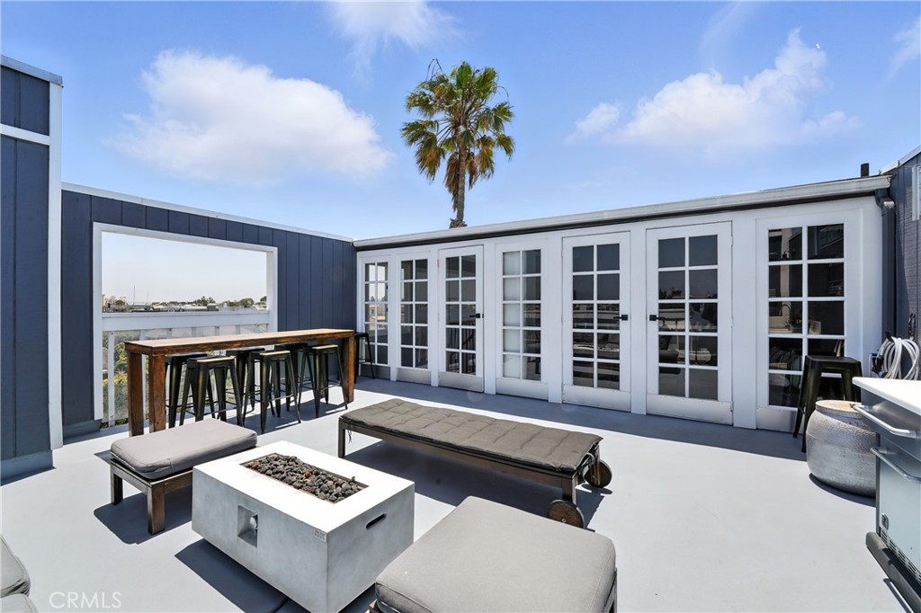 a balcony with furniture and a potted plant