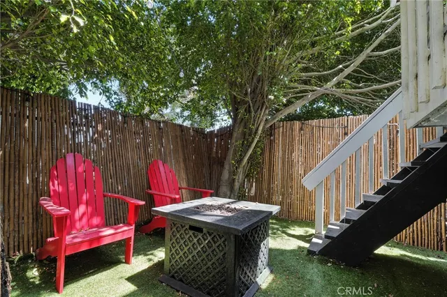 a view of a patio with couches table and chairs with wooden floor