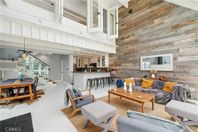 a view of a patio with couches table and chairs with wooden floor