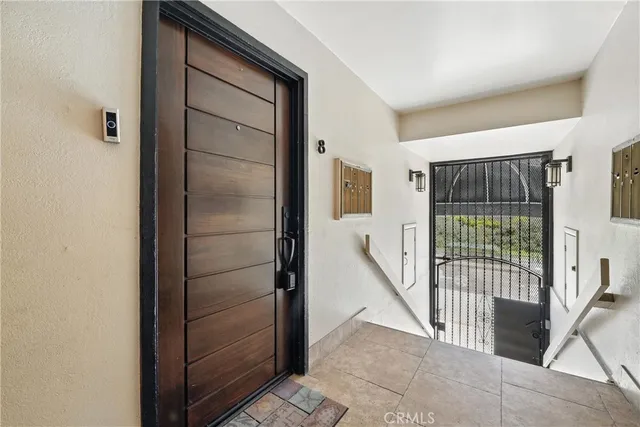 a view of a hallway with furniture and a window