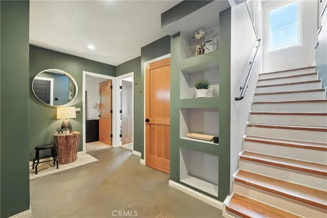 a living room with furniture and a mirror