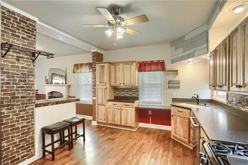 392 Reno Street Rochester, PA 15074 - Photo 17 of 41 a kitchen with granite countertop a stove a sink and a refrigerator