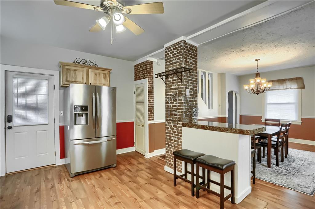 392 Reno Street Rochester, PA 15074 - Photo 18 of 41 a kitchen with stainless steel appliances a dining table chairs refrigerator and cabinets