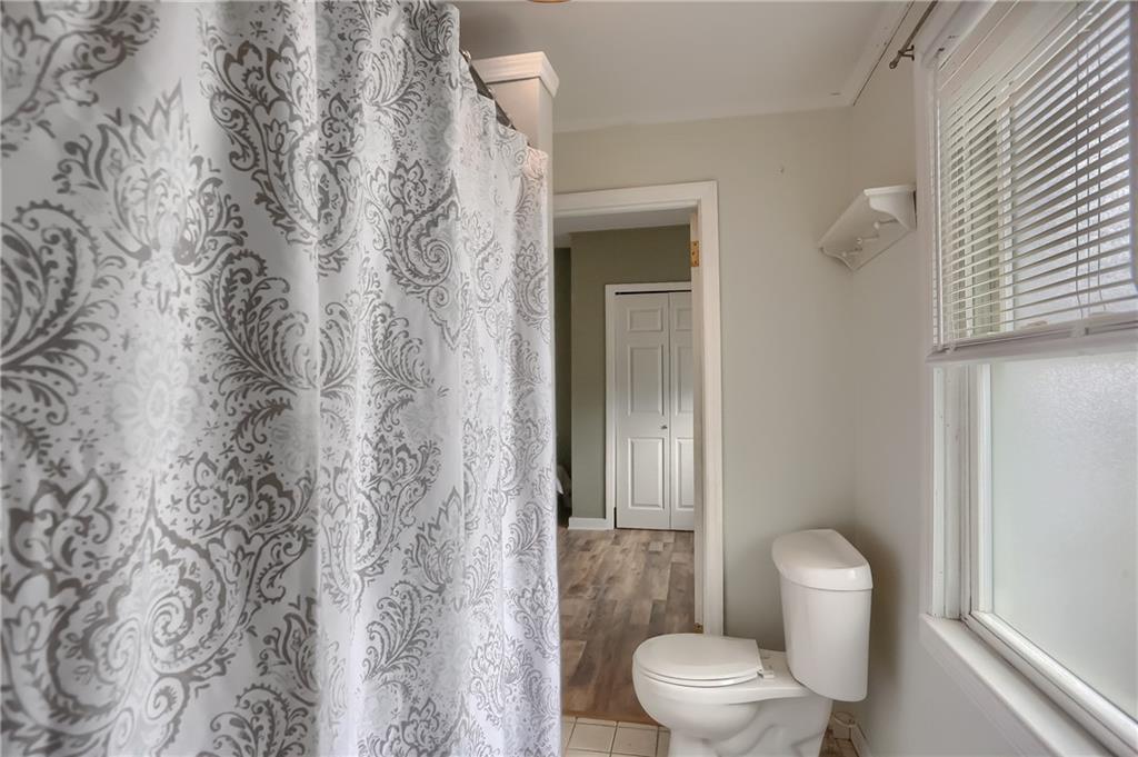392 Reno Street Rochester, PA 15074 - Photo 27 of 41 a white toilet sitting next to a shower curtain