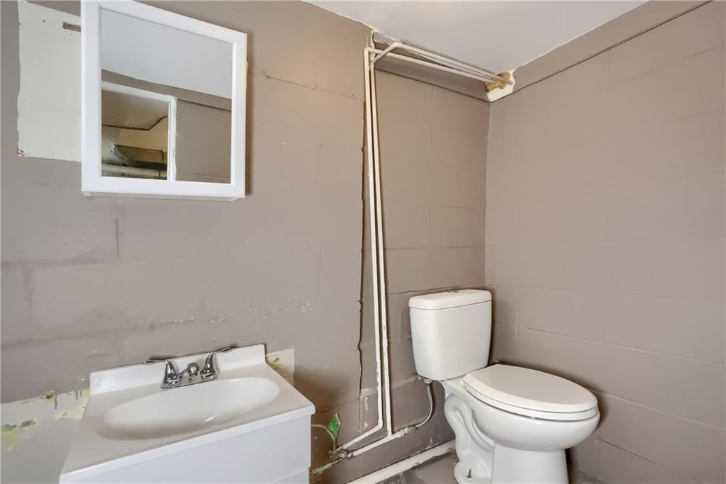 392 Reno Street Rochester, PA 15074 - Photo 29 of 41 a white toilet sitting next to a bathroom sink