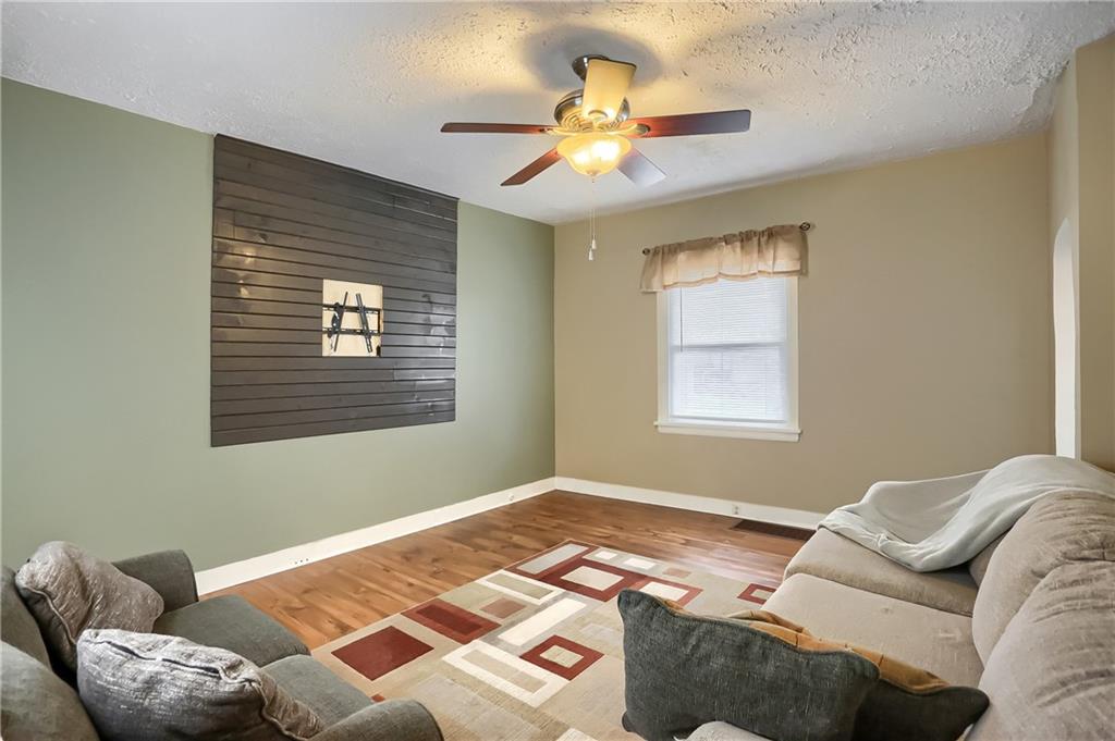 392 Reno Street Rochester, PA 15074 - Photo 7 of 41 a bedroom with a bed couch and window