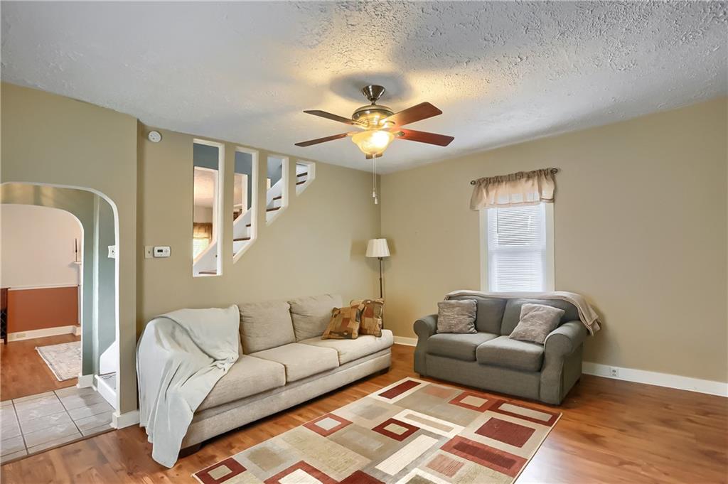 392 Reno Street Rochester, PA 15074 - Photo 8 of 41 a living room with furniture and a chandelier