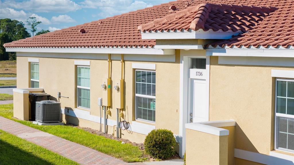 1736 Pacific Road Kissimmee, FL 34759 - Photo 11 of 42 a front view of a house with a garden
