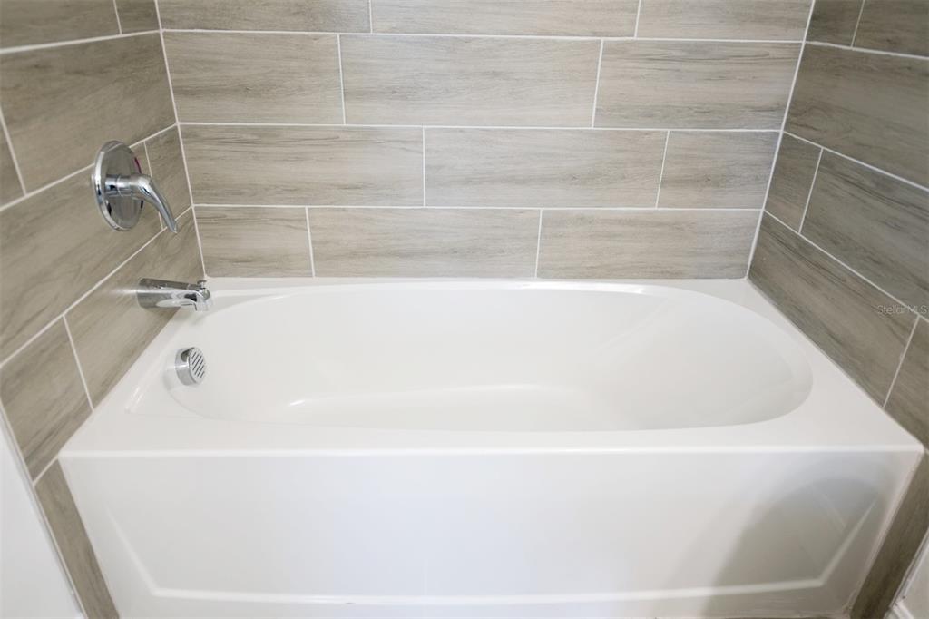 1736 Pacific Road Kissimmee, FL 34759 - Photo 14 of 42 a bathroom with a bathtub