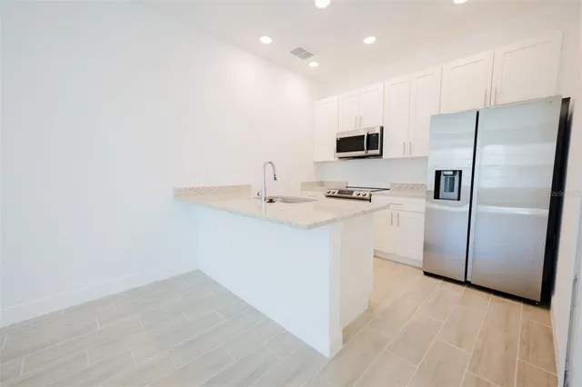 a kitchen with a refrigerator sink and microwave
