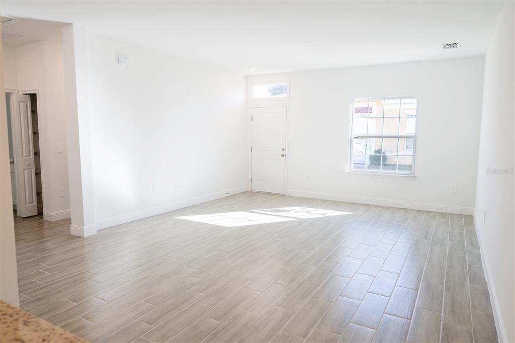 1736 Pacific Road Kissimmee, FL 34759 - Photo 23 of 42 an empty room with wooden floor and windows