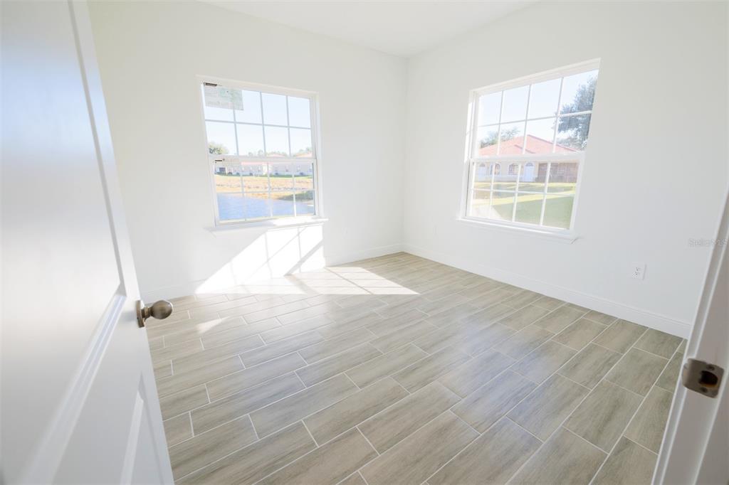 1736 Pacific Road Kissimmee, FL 34759 - Photo 27 of 42 an empty room with wooden floor and windows