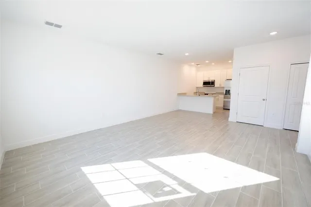 a view of a kitchen with wooden floor