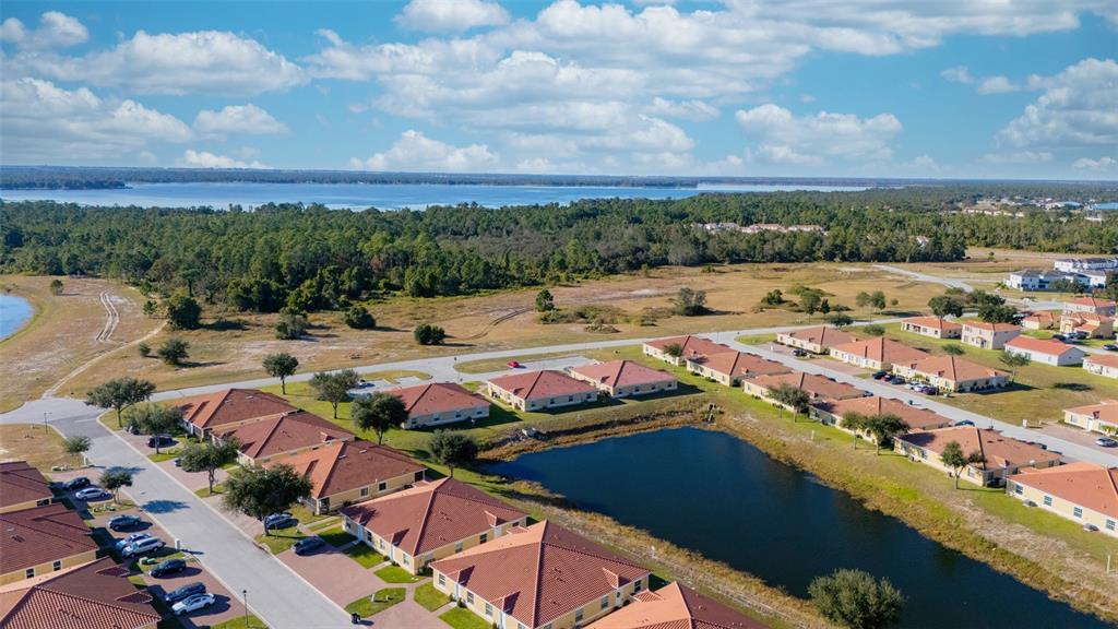 1736 Pacific Road Kissimmee, FL 34759 - Photo 34 of 42 an aerial view of a city with lots of residential buildings ocean and mountain view in back