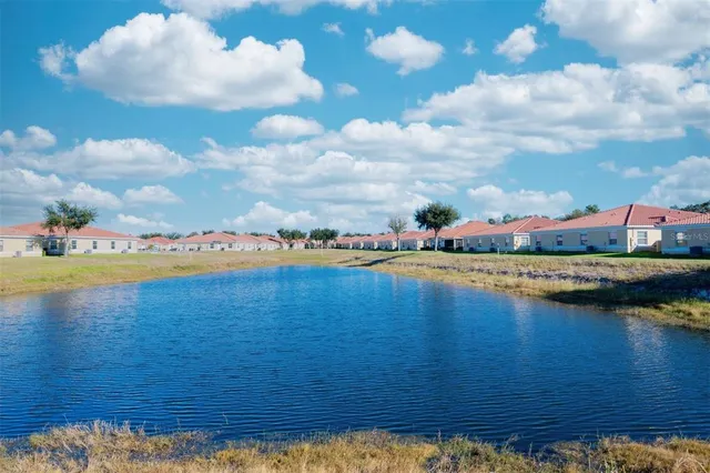 a view of a lake with houses in the back