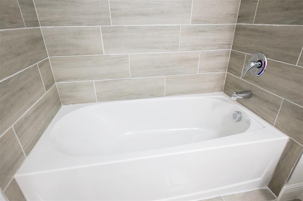 1736 Pacific Road Kissimmee, FL 34759 - Photo 10 of 42 a white bath tub sitting in a bathroom