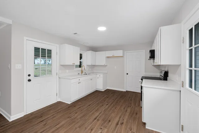 a kitchen with a refrigerator stove and sink